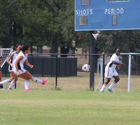 Female Soccer Players on Field Playing